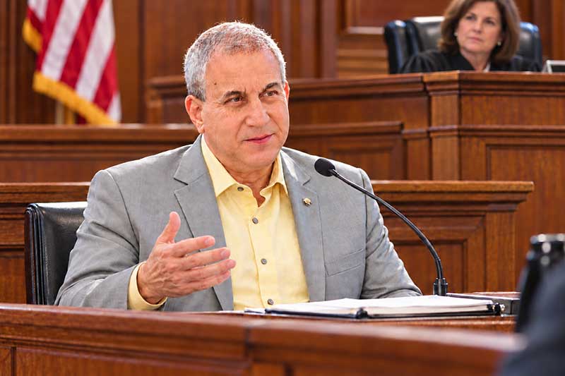 Judge seated behind Jeff the expert witness